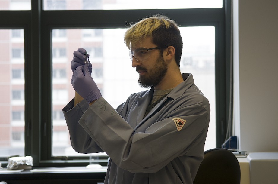 scientist looking  at test tube
